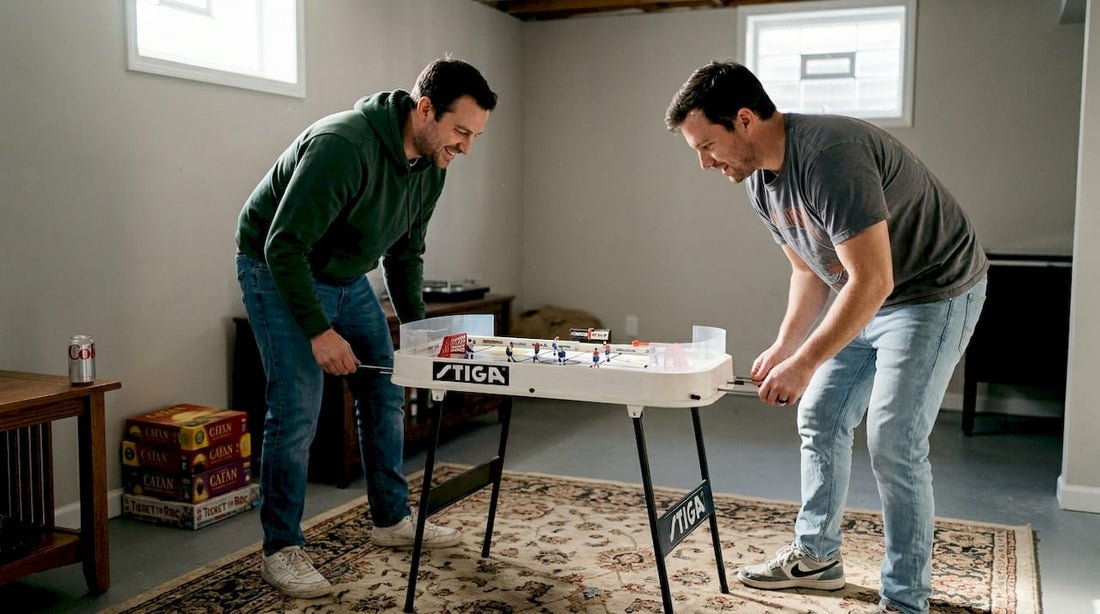 Friends playing home table hockey basement
