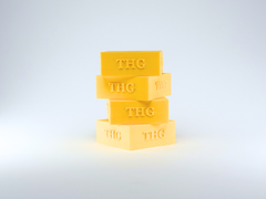 Stack of four yellow THG table hockey holders on a white background