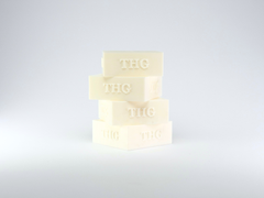 Stack of four white THG table hockey holders on a light grey background