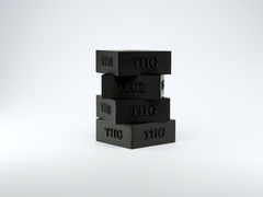 Stack of four black THG table hockey holders on a white background