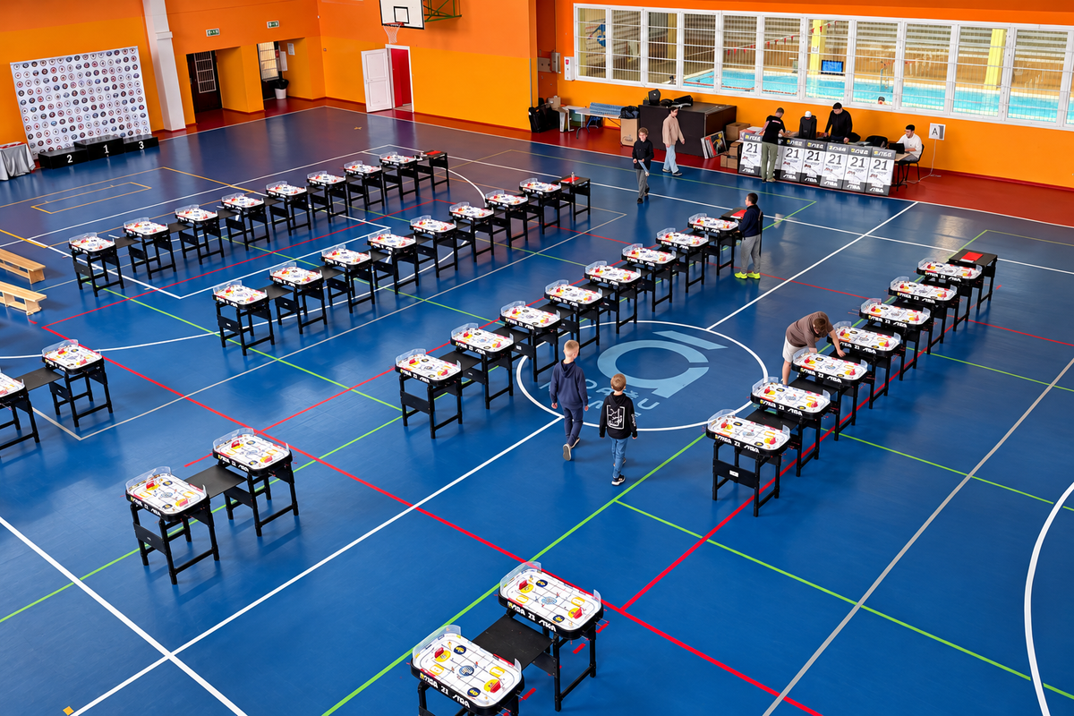 Rows of table hockey tables set up in a large hall